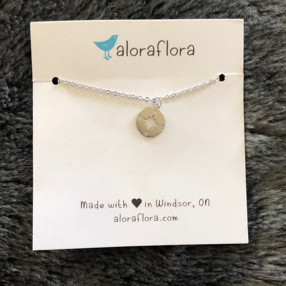 Aloes Flora NWT Silver necklace. NESW compass